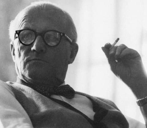 A portrait of Pierre Jeanneret smoking a cigarette
