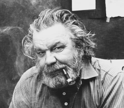 A portrait of Tapio Wirkkala smoking a pipe